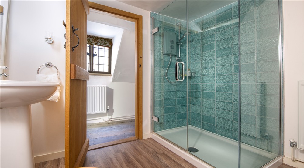 The en-suite shower room of Bedroom 4 Umfreville, on the second floor of Thorington Hall, Suffolk at Thorington Hall in Stoke By Nayland, Suffolk
