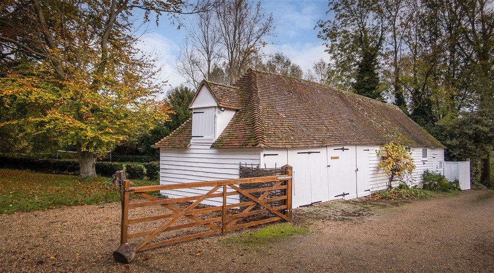 The outbuildings, where bicycles and equipment can be stored, at Thorington Hall in Stoke By Nayland, Suffolk