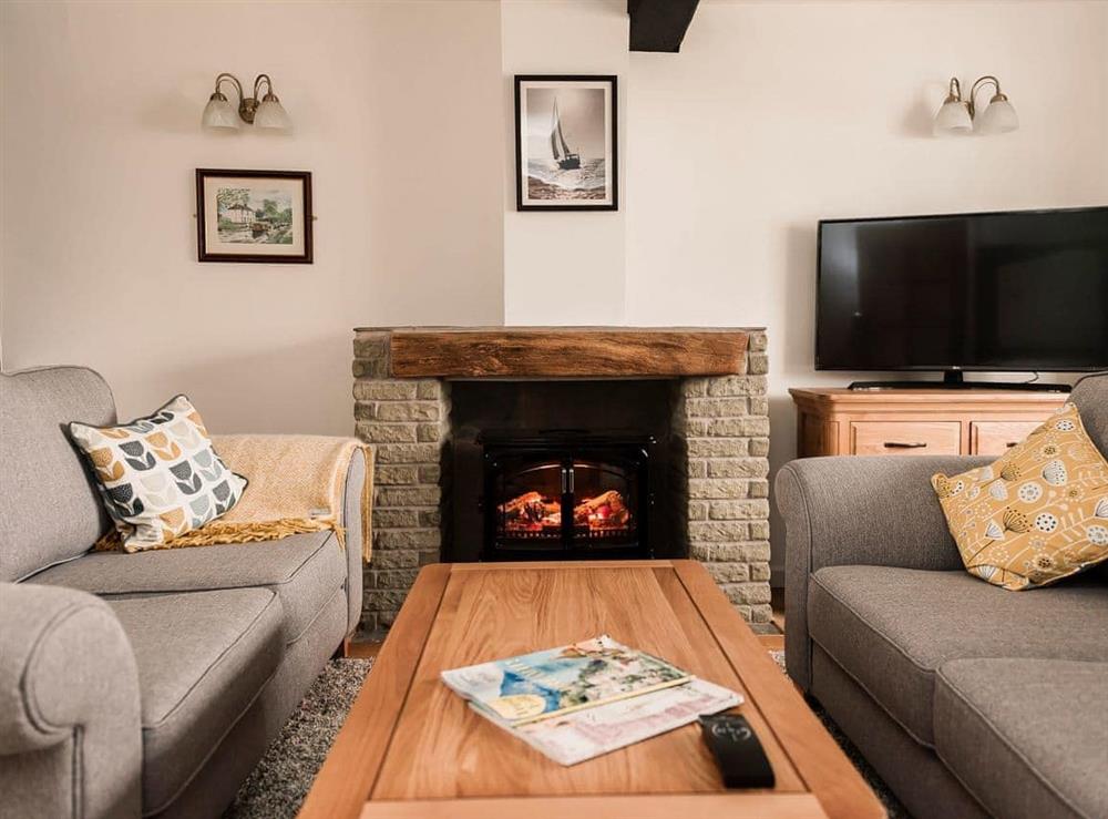 Cosy living room with electric wood burner (photo 2) at Three Batch Cottages in Chaddesley Corbett, near Bromsgrove, Worcestershire
