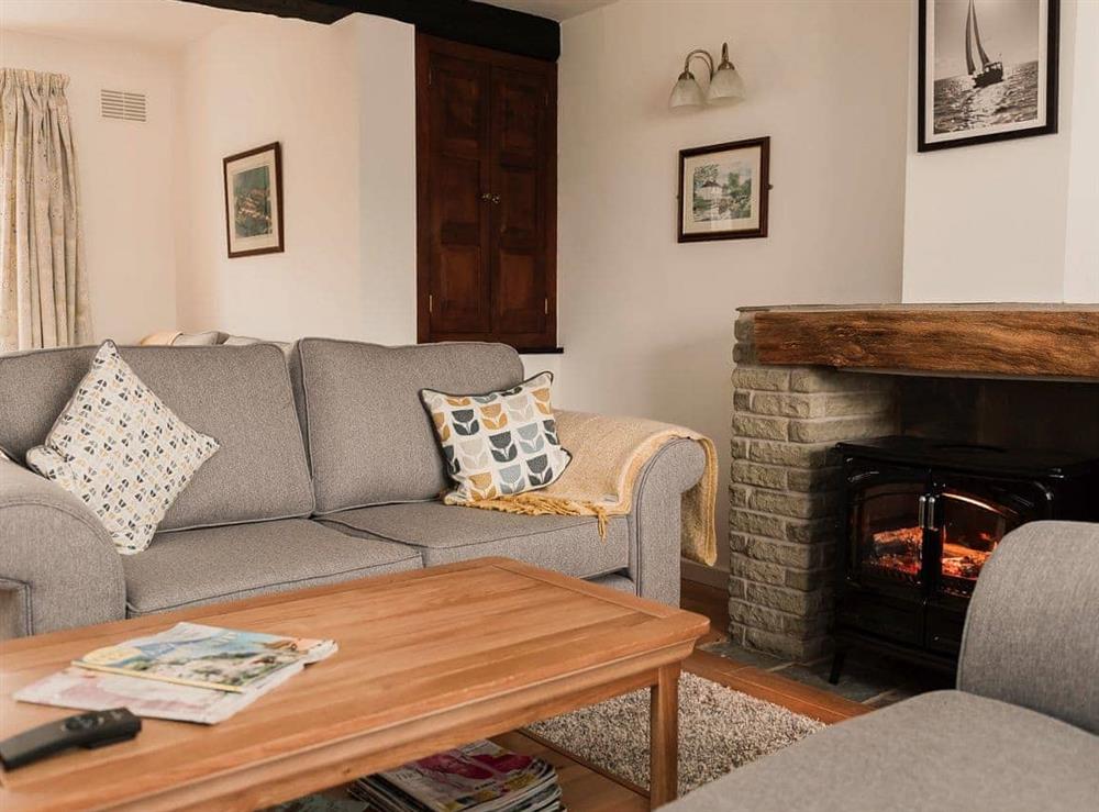 Cosy living room with electric wood burner (photo 3) at Three Batch Cottages in Chaddesley Corbett, near Bromsgrove, Worcestershire
