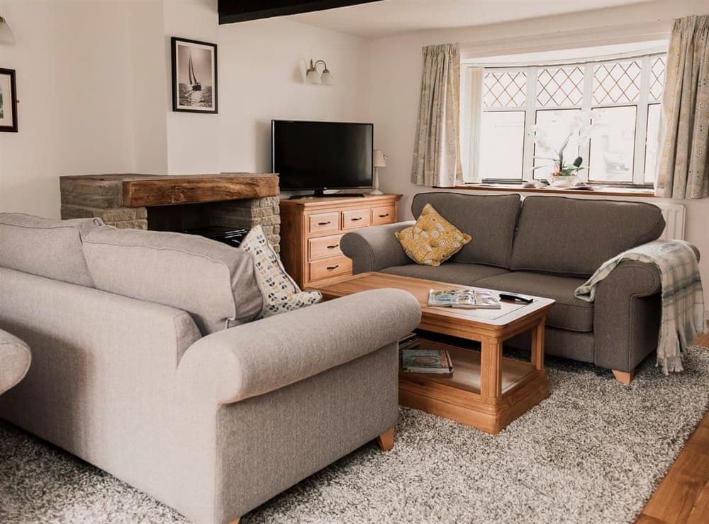 Cosy living room with electric wood burner at Three Batch Cottages in Chaddesley Corbett, near Bromsgrove, Worcestershire