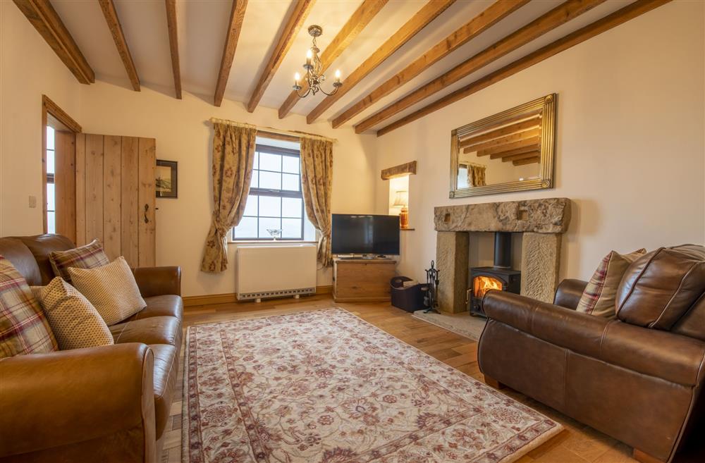 Sitting room featuring exposed beams at Threpnybit Cottage, Pockley