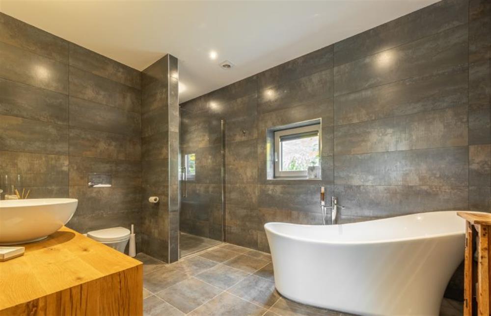 Ground floor: En-suite bathroom has freestanding bath and separate shower cubicle at Thursford Castle, Great Snoring