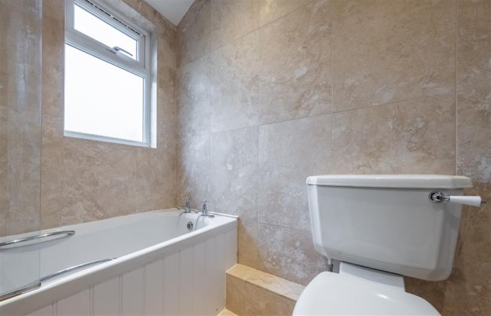 First floor: En-suite bathroom at Thyme Cottage, Thornham near Hunstanton