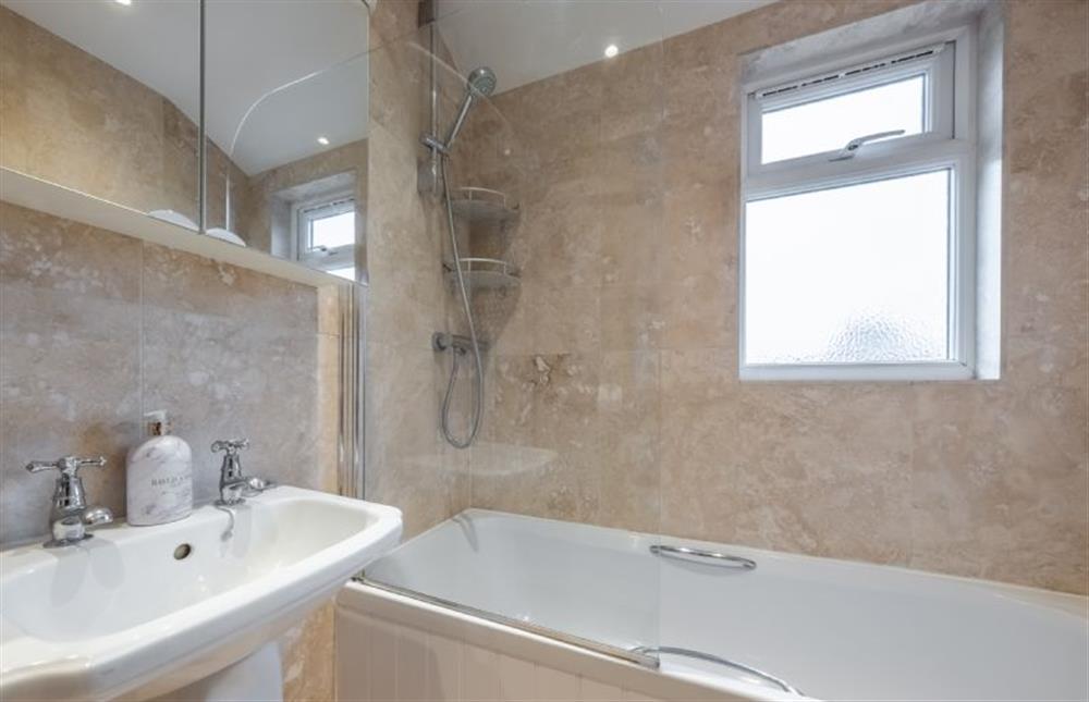 First floor: En-suite has a WC, wash basin, bath with shower over at Thyme Cottage, Thornham near Hunstanton