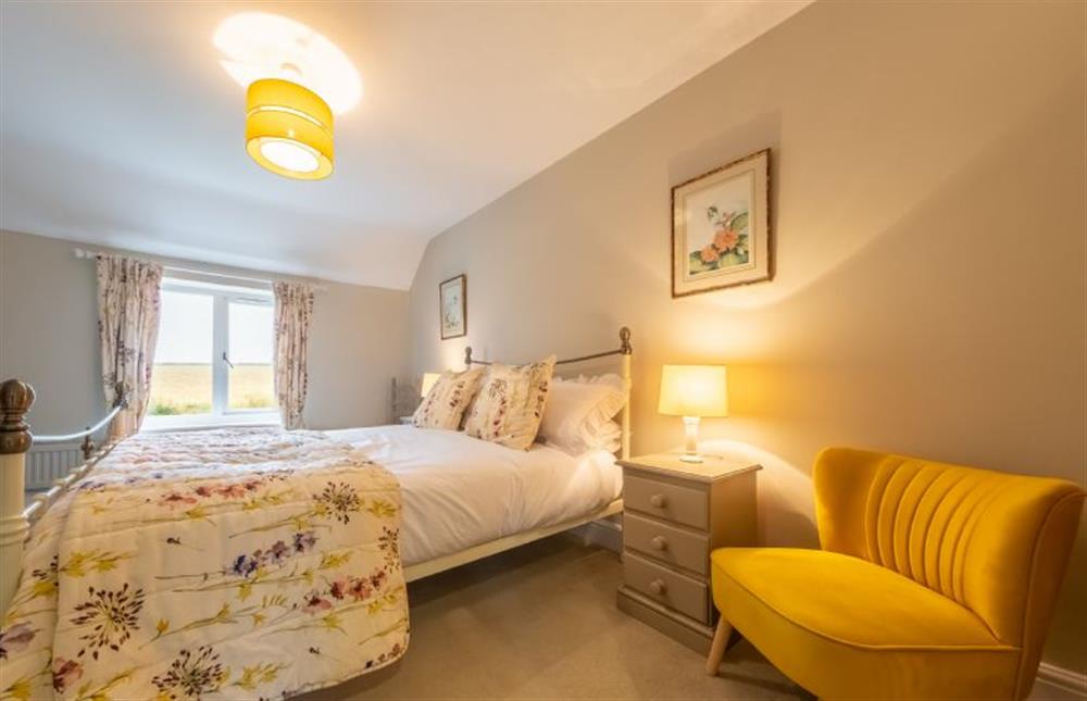 First floor: The master bedroom has a king-size bed at Thyme Cottage, Thornham near Hunstanton