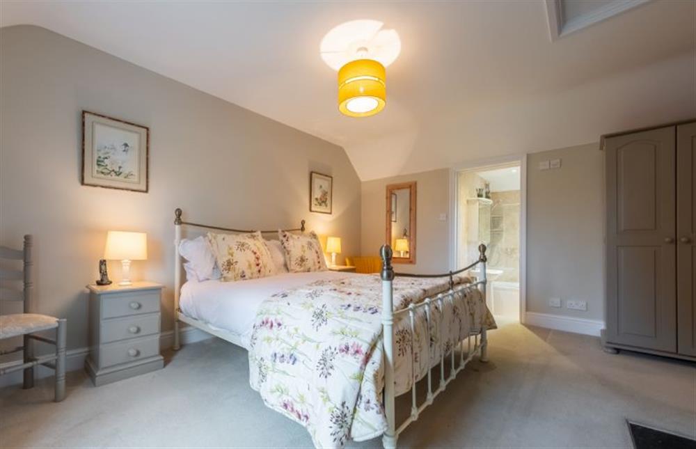 First floor:  The master bedroom has an en-suite bathroom at Thyme Cottage, Thornham near Hunstanton