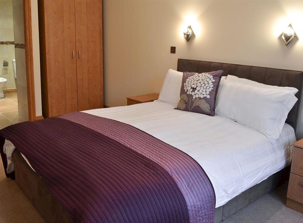 Contemporary style double bedroom leading to en-suite at Peartree Apartment 3, 
