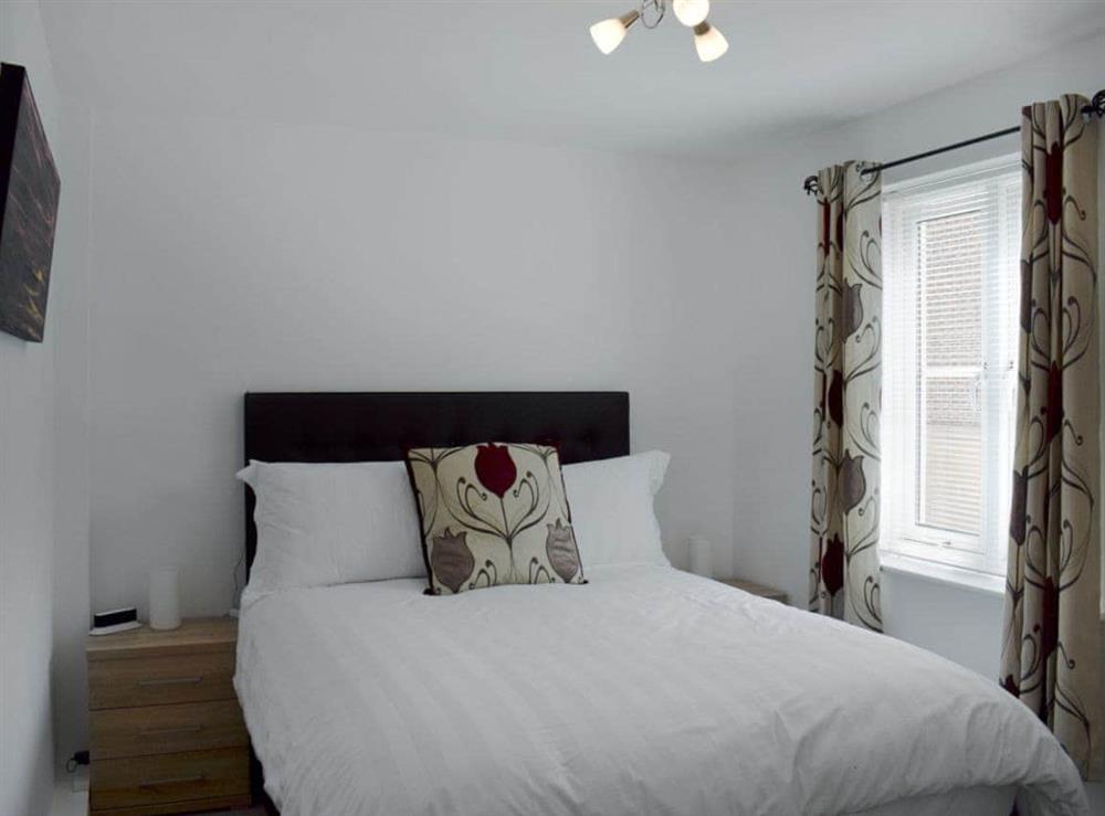 Comfortable double bedroom with kingsize bed at Tidal Retreat in Whitby, North Yorkshire