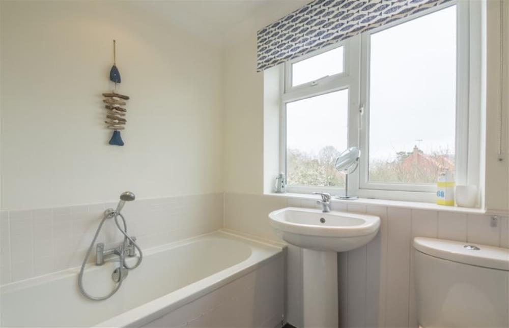 First floor: Family bathroom with a double ended bath and shower attachment at Tide Cottage, Holme-next-the-Sea near Hunstanton
