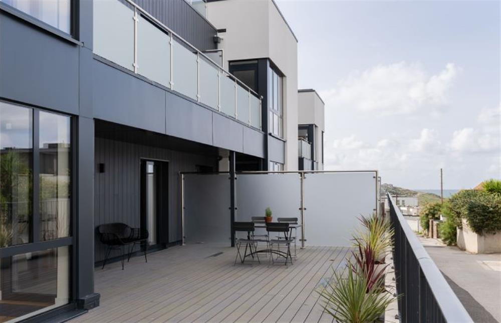 Decked area with outdoor furniture seating up to four guests at Tidelines, Newquay