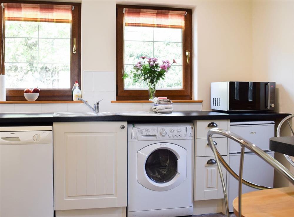 Kitchen with laundry facilities at Little Tigh Craggan, 