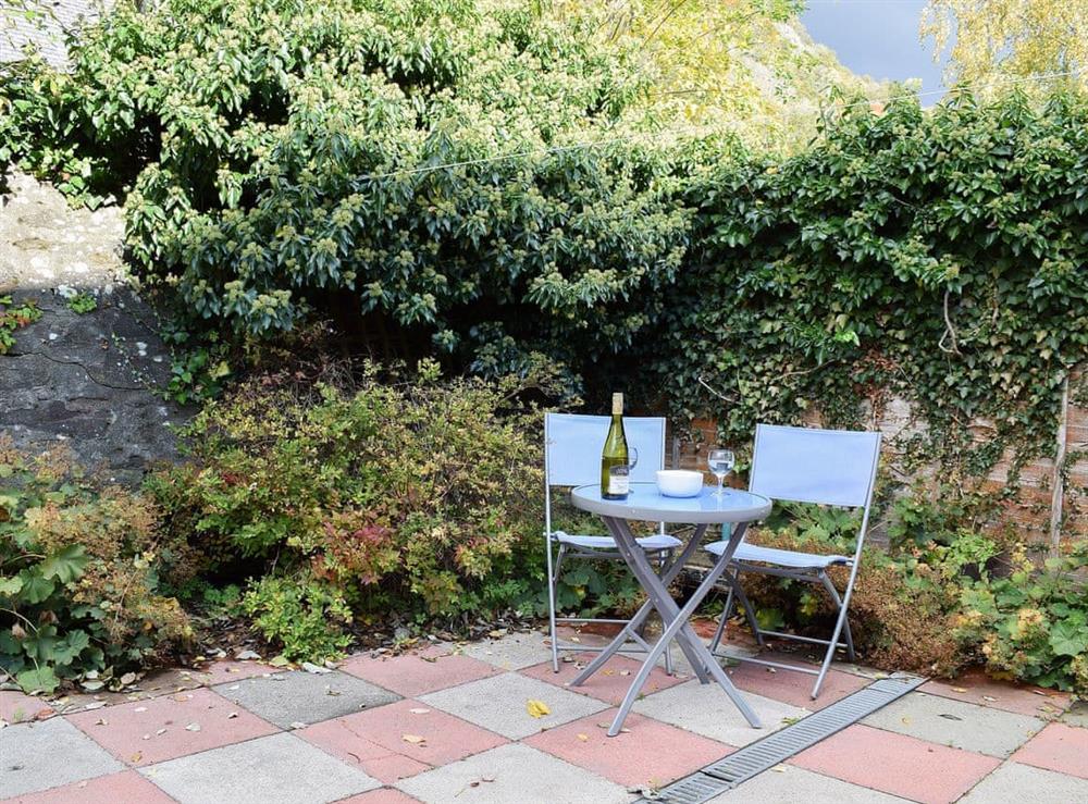 Paved patio area with table and chairs at Little Tigh Craggan, 