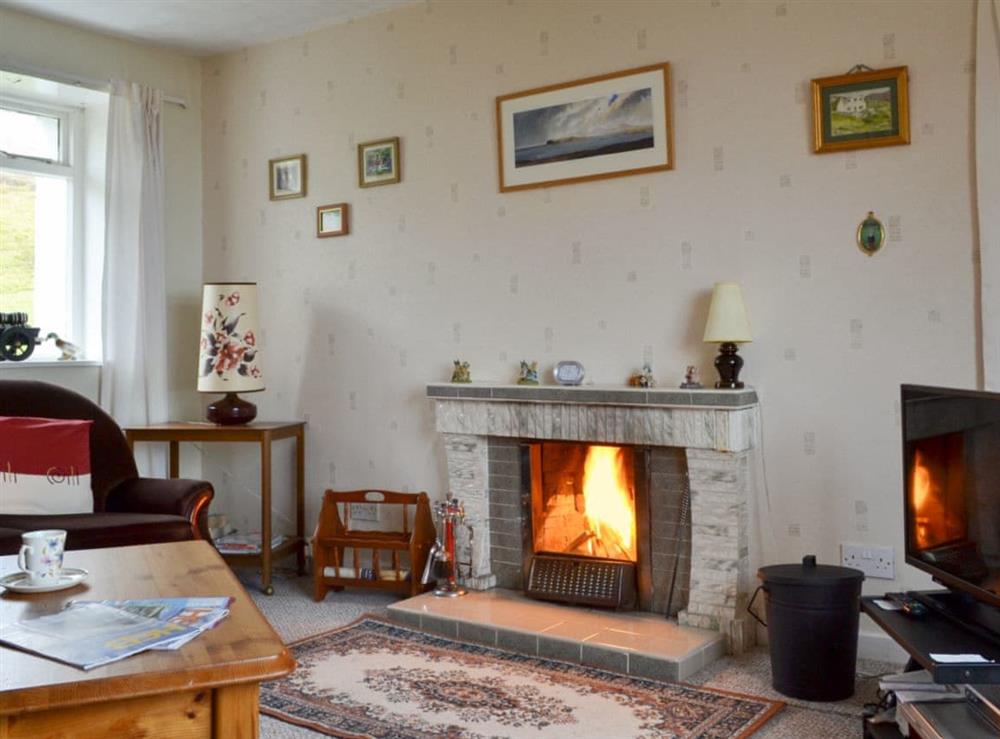 Comfortable living room with an open fire at Tigh Mairi in Carragrich, near Tarbert, Isle of Harris, Outer Hebrides., Scotland