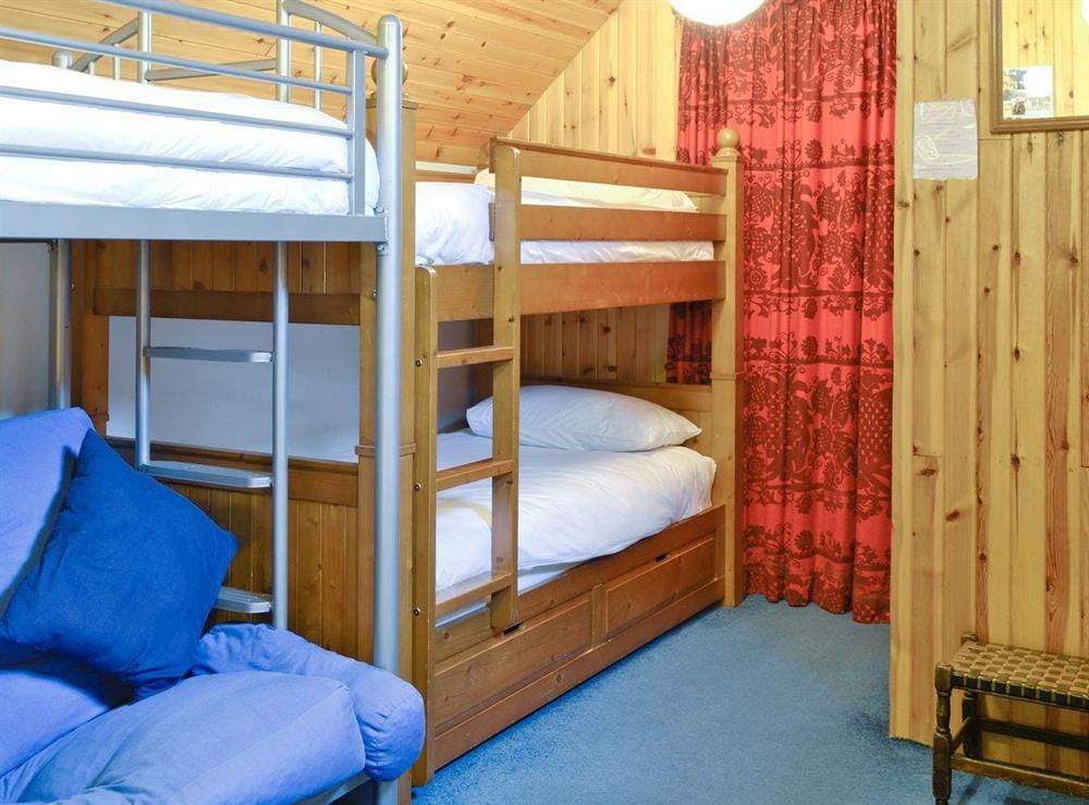 Double bunk room with extra bed and seating at Tigh na Caoiraich in Invergarry, Tomdoun, Inverness-Shire