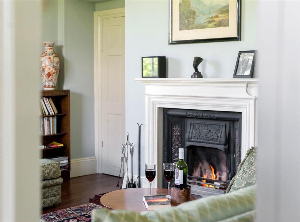 Cosy living room with open fire at Tilney Hall in Kings Lynn, Norfolk