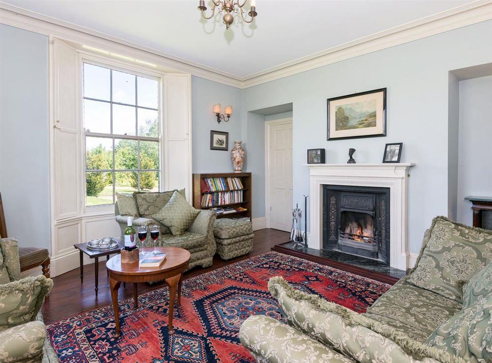 Spacious living room with open fire at Tilney Hall in Kings Lynn, Norfolk