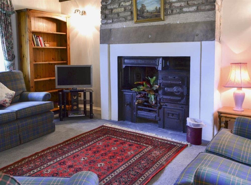 Living room with ornamental period range at Timberwick Green in Akeld, Wooler, Northumberland., Great Britain
