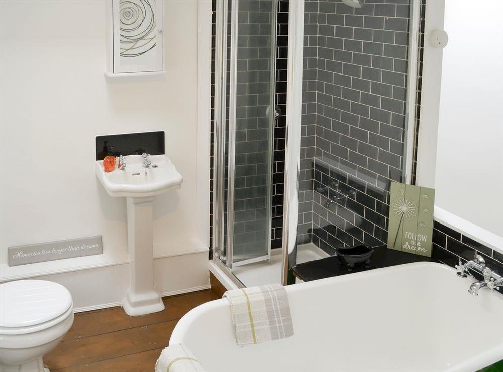 Bathroom with free standing bath and separate shower cubicle at Time Cottage in Coltishall, near Wroxham, Norfolk, England