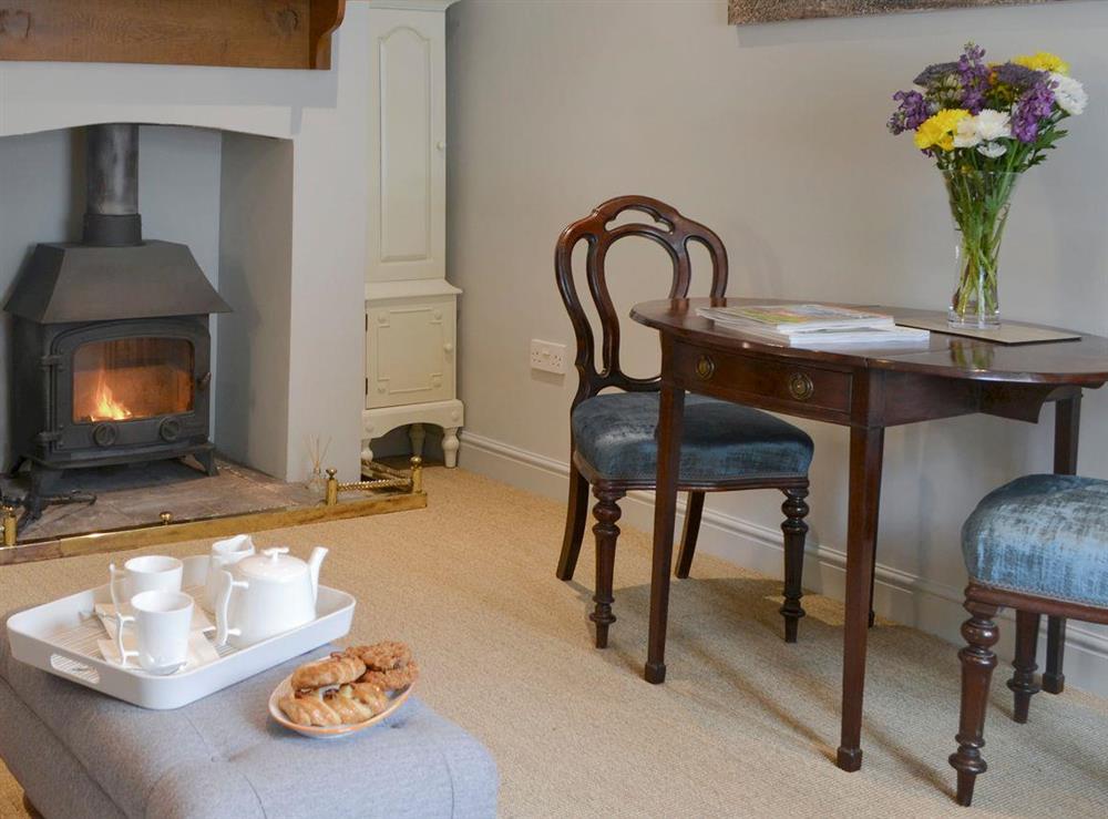 Warm and welcoming living and dining room at Time Cottage in Coltishall, near Wroxham, Norfolk, England