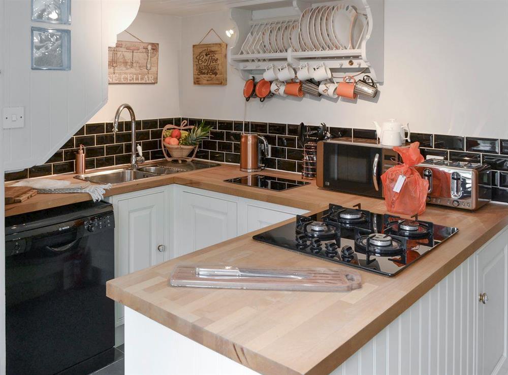 Well-equipped fitted kitchen at Time Cottage in Coltishall, near Wroxham, Norfolk, England
