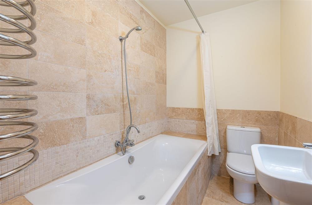 An en-suite with a shower over the bath