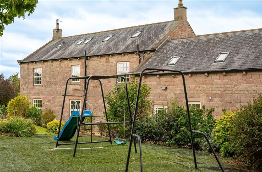 The children's play area with a slide and swing set