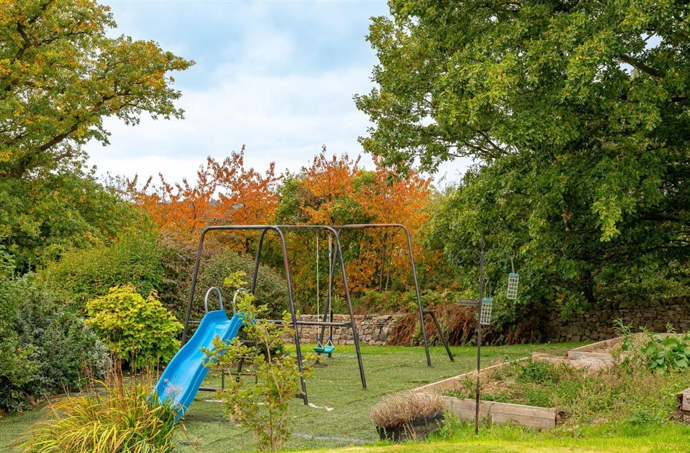 The children's play area with a slide and swing set