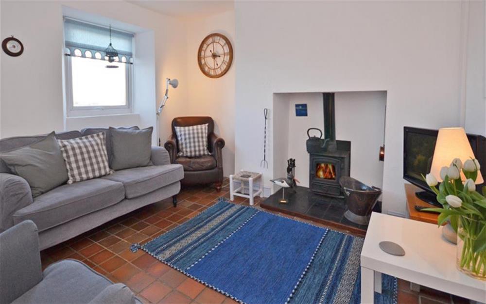 The comfortable sitting room with cosy wood burner fire. at Tinsey Cottage in Beesands