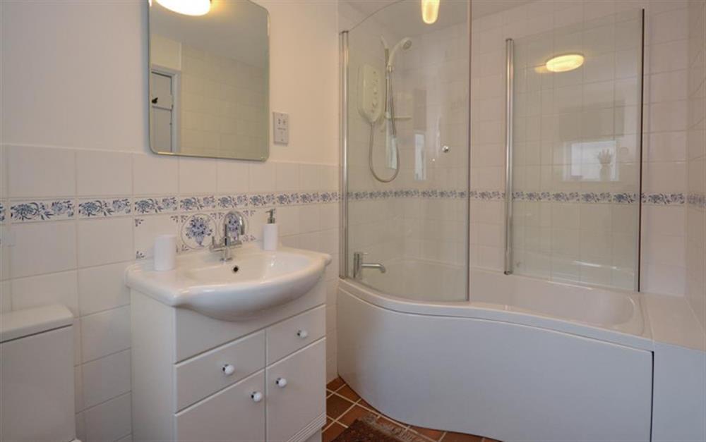 The modern bathroom with shower over the bath. at Tinsey Cottage in Beesands