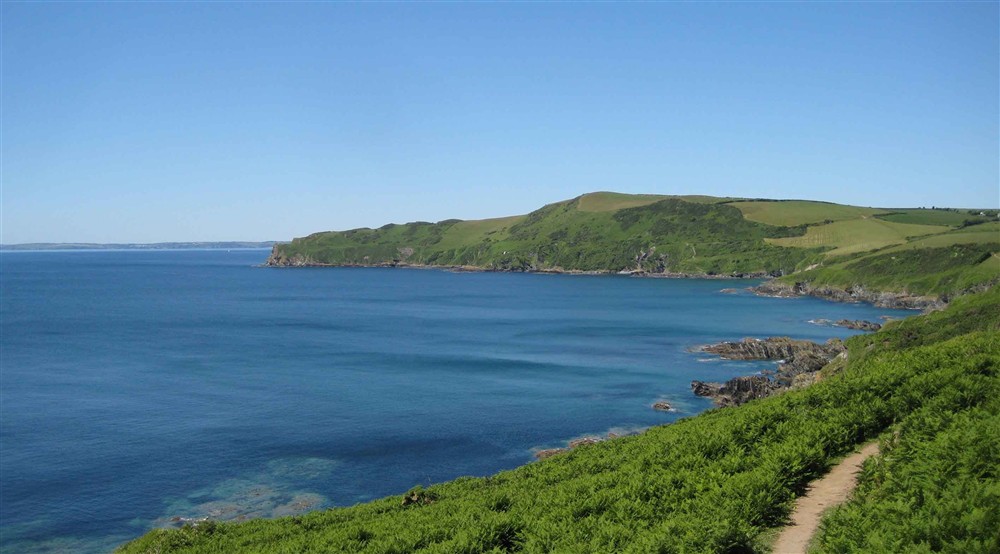 View over Lantivet Bay, Cornwall, in the sunshine with coast path to the right. at Tippett's in Lanteglos-by-fowey, Cornwall