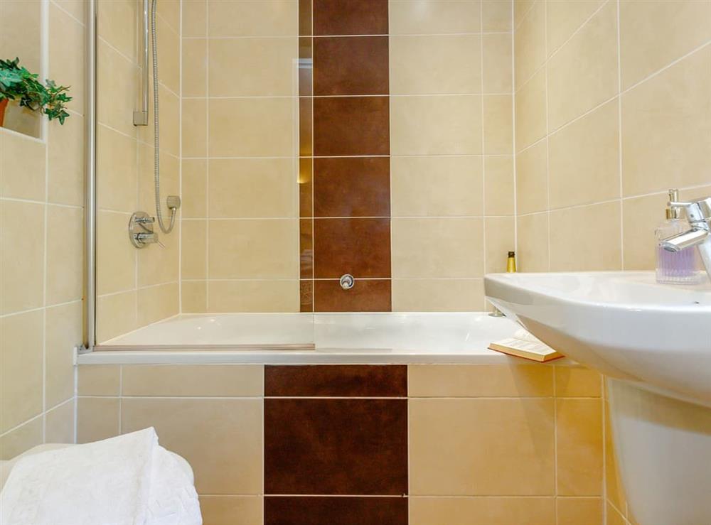 En-suite Bathroom with shower over bath at Tissington Ford Barn in Bradbourne, Derbyshire
