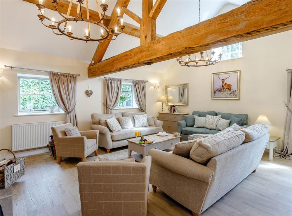 Spacious living room with exposed wood beams at Tissington Ford Barn in Bradbourne, Derbyshire