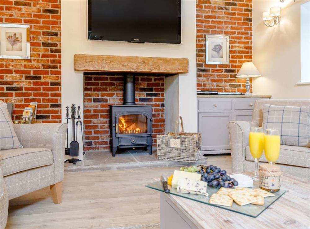 Welcoming living area with wood burner at Tissington Ford Barn in Bradbourne, Derbyshire