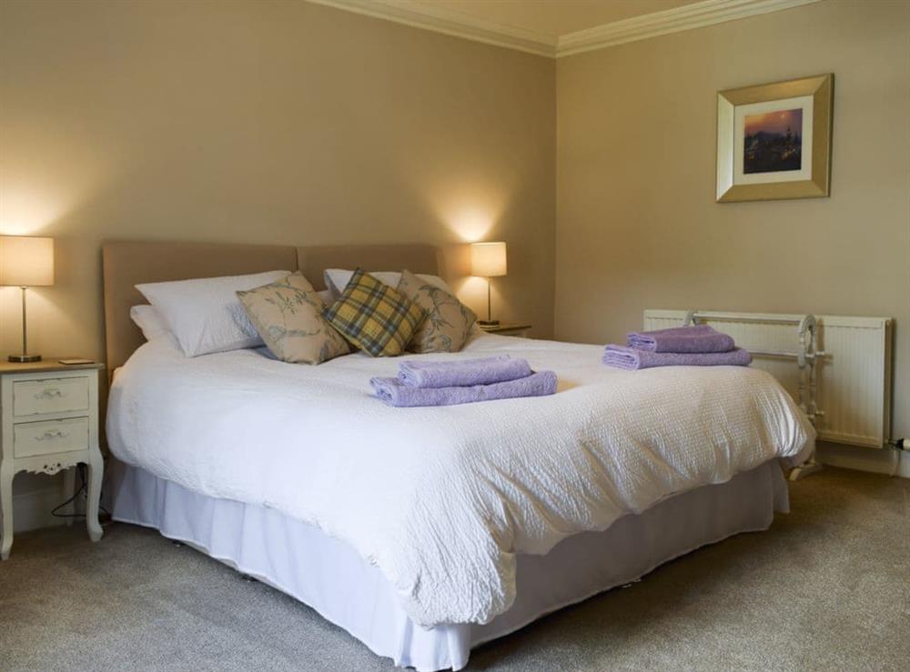 Comfortable bedroom with zip and link super kingsize bed at Toad Hall in Aberfeldy, Perthshire