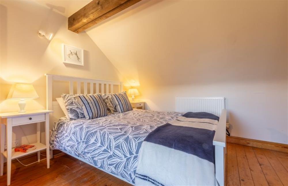 First floor: Master bedroom with king-size bed at Toad Hall, Burnham Deepdale near Kings Lynn