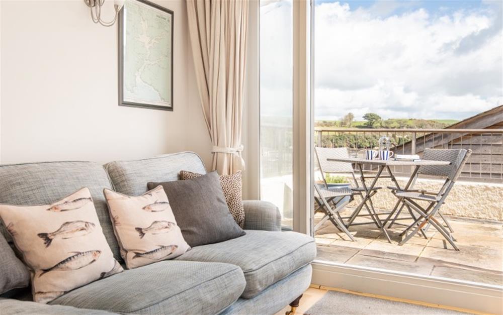 Cosy sitting room with french doors onto the sunny 1st floor balcony at Toad's Pad in Salcombe
