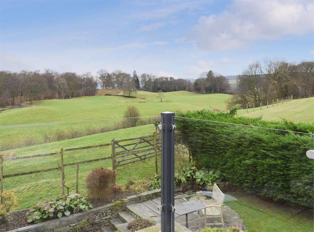 Balcony overlooking the garden and the rural countryside beyond at Tock How View in Outgate, Hawkshead, Cumbria., Great Britain