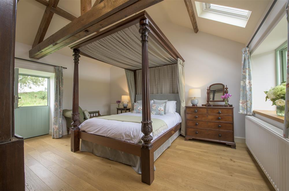 Bedroom five with a 5’ king size four-poster bed and en suite shower room at Todd Hills Hall Farmhouse and Vale Croft, Melmerby