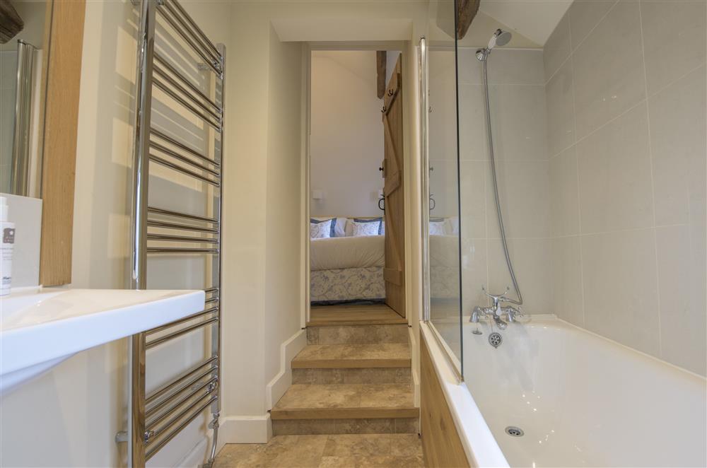 En-suite bathroom to bedroom three with a bath and hand-held shower attachment at Todd Hills Hall Farmhouse and Vale Croft, Melmerby