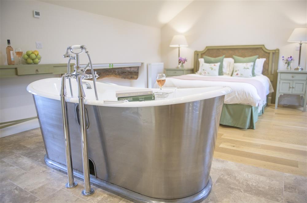 Free-standing cast iron bath in bedroom four at Todd Hills Hall Farmhouse and Vale Croft, Melmerby