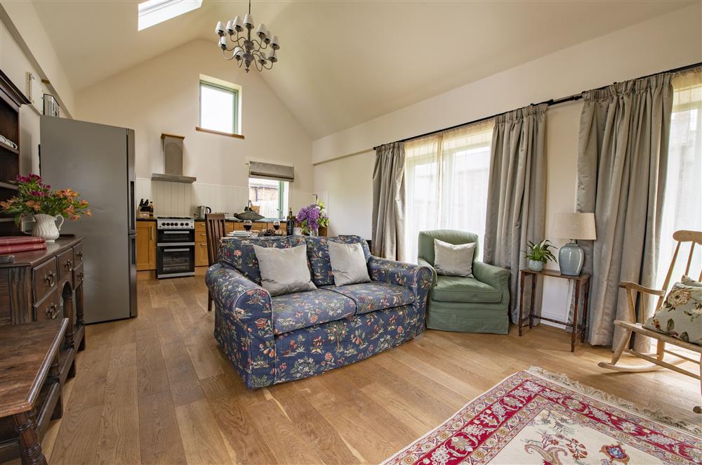 Open-plan kitchen, dining and sitting room with wood burning stove at Todd Hills Hall Farmhouse and Vale Croft, Melmerby