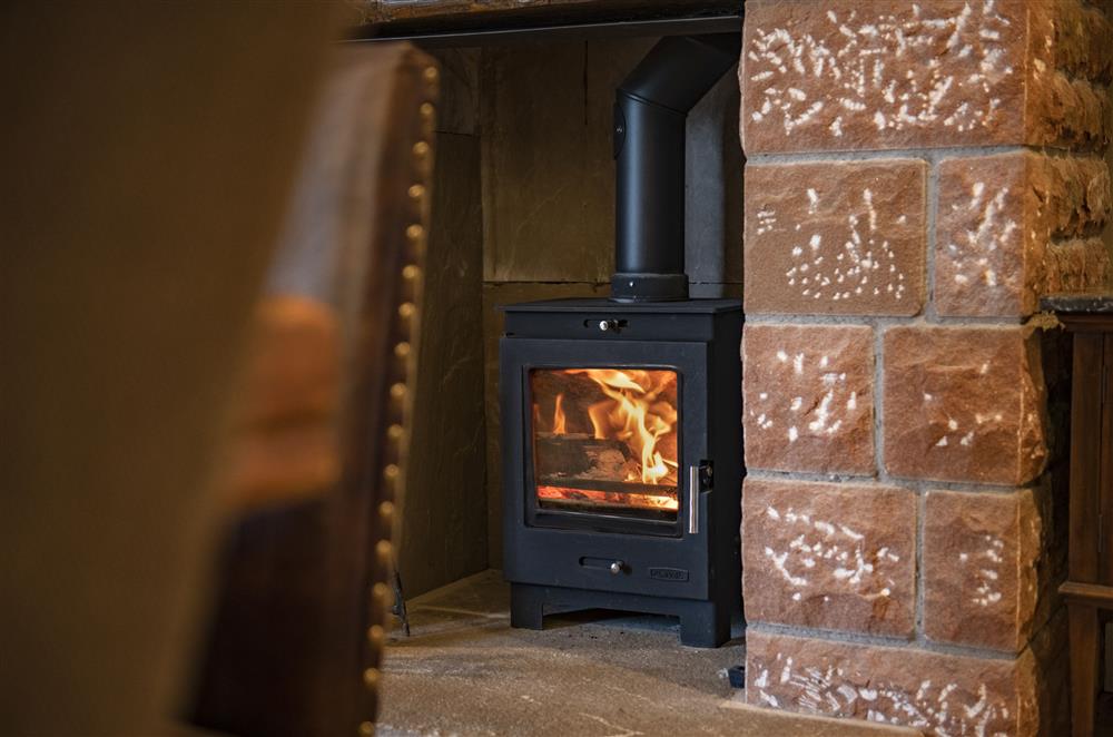 Wood burning stove in the dining room at Todd Hills Hall Farmhouse and Vale Croft, Melmerby