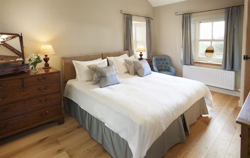 Bedroom 1 with 6’ zip and link double bed and en-suite shower room at Todd Hills Hall Farmhouse, Melmerby