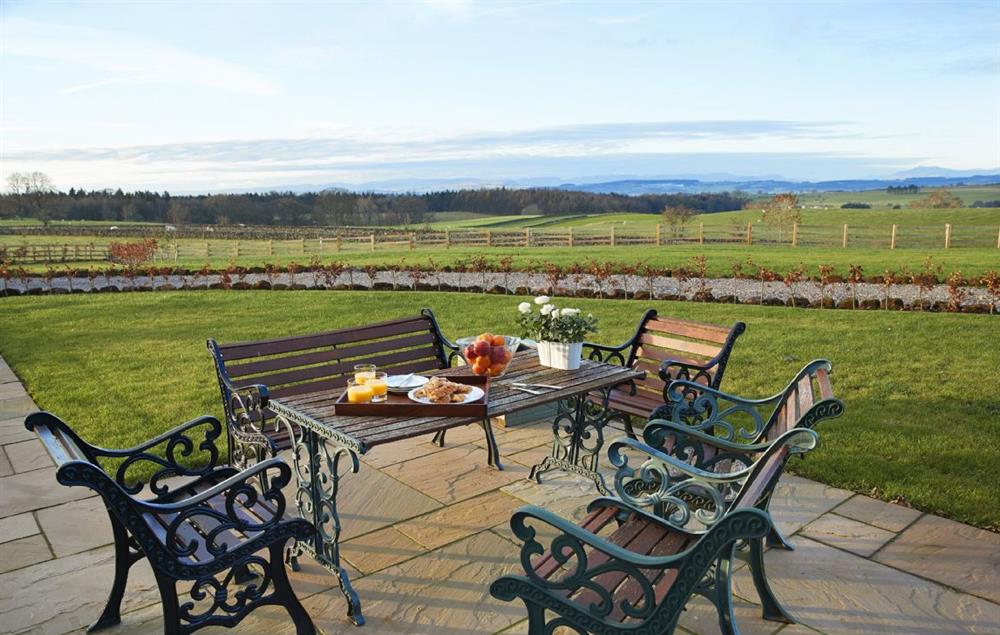 Extensive sandstone terrace with garden furniture  (photo 2) at Todd Hills Hall Farmhouse, Melmerby