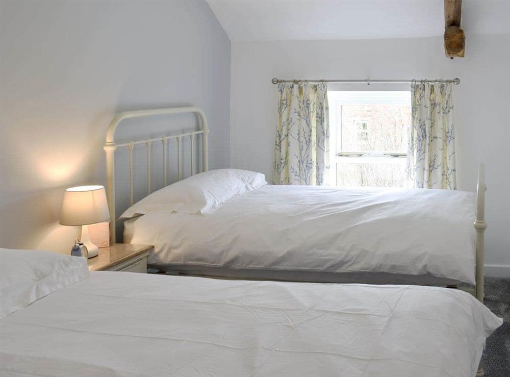 Bedroom with single bed and pull-out single bed at Toms Cottage in Melmerby, near Penrith, Cumbria