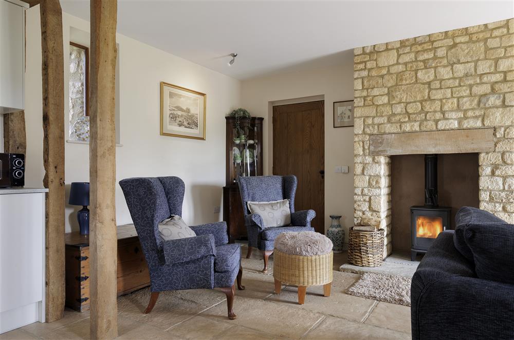 Cosy sitting room with exposed beams and stonework