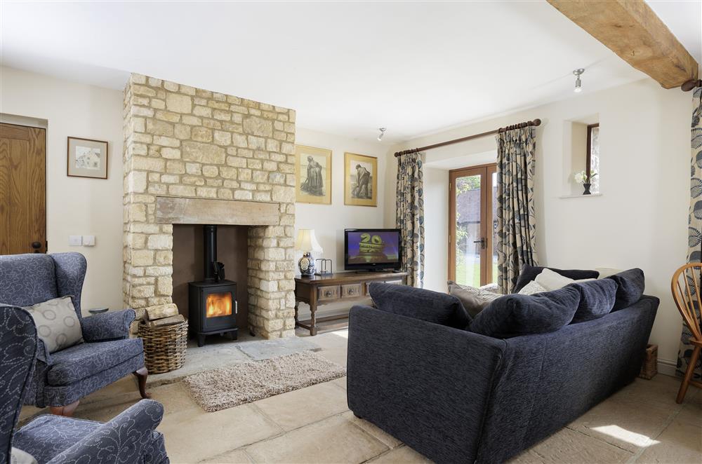 Light and bright sitting room with a wood burning stove