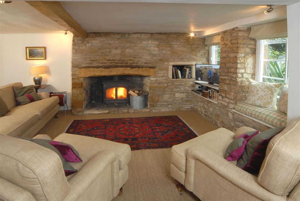 Cosy sitting room with inglenook fireplace, bread oven and wood burning stove (photo 2) at Top Cottage, Oddington, Upper Oddington