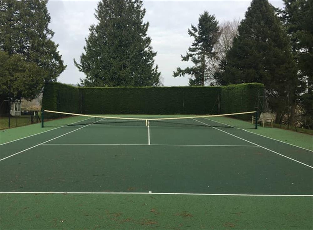 Tennis court at Tor Hatch Cottage in Guildford, Surrey